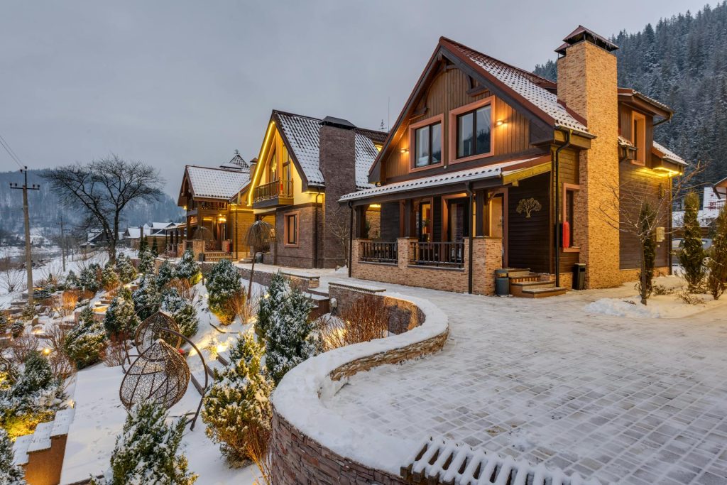 Luxury Swiss Alps chalets with snow-covered mountains and winter garden 2025